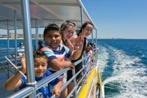 children waving on dolphin cruise boat tour in destin florida